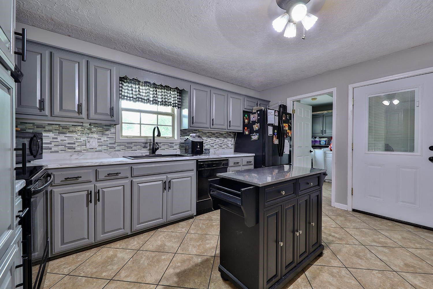 1217 Hyndsver Road Martin, TN 38237 - Photo 7 of 23 a kitchen with stainless steel appliances granite countertop a sink counter space cabinets and a window