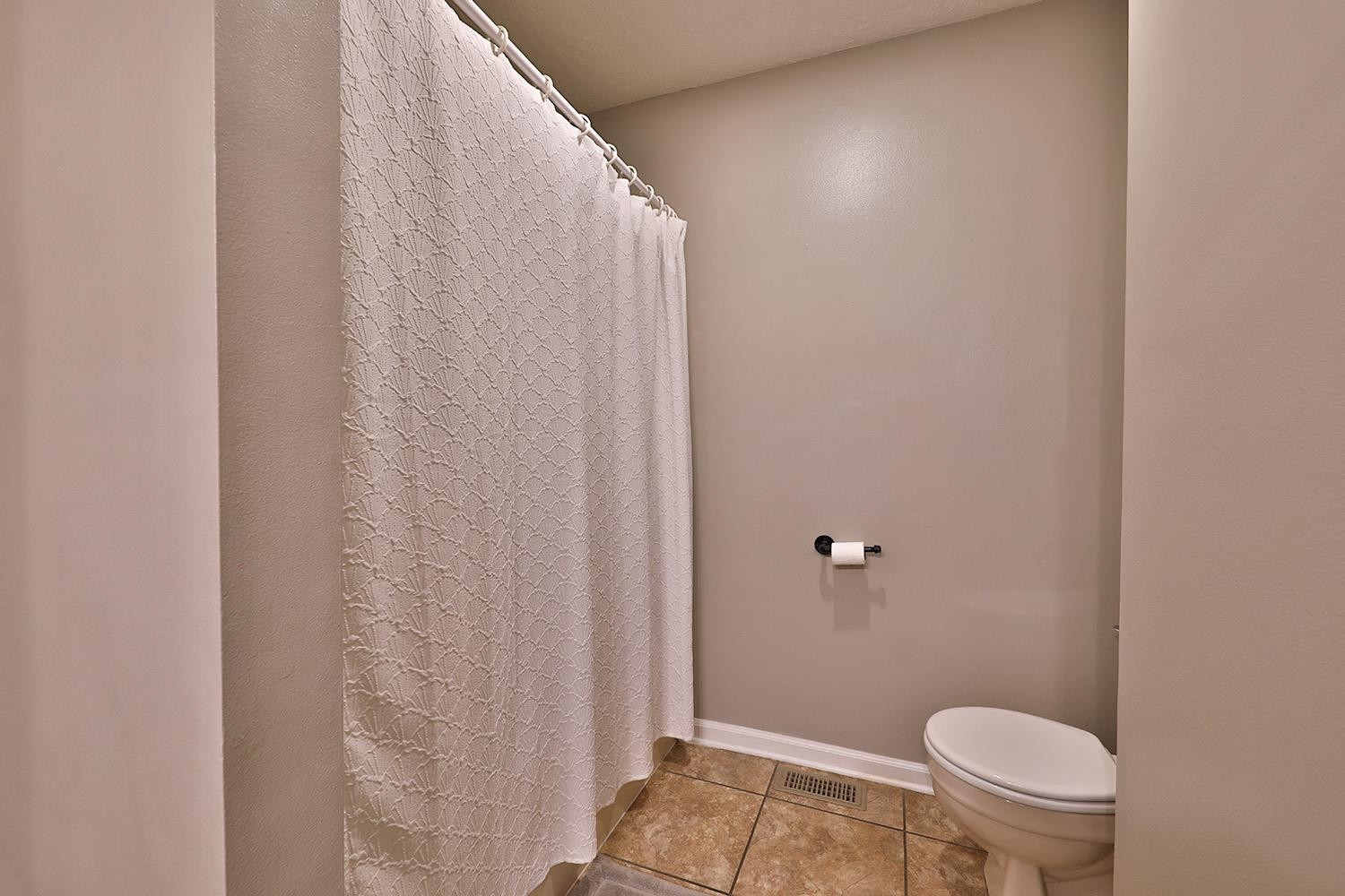 1217 Hyndsver Road Martin, TN 38237 - Photo 10 of 23 a bathroom with a toilet and a shower curtain