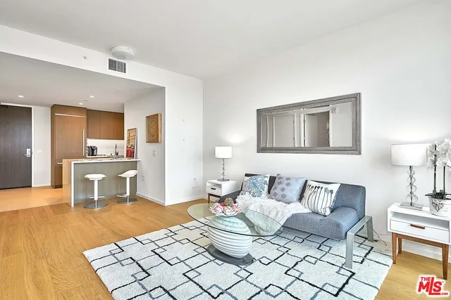 a large bed sitting in a bedroom next to a window