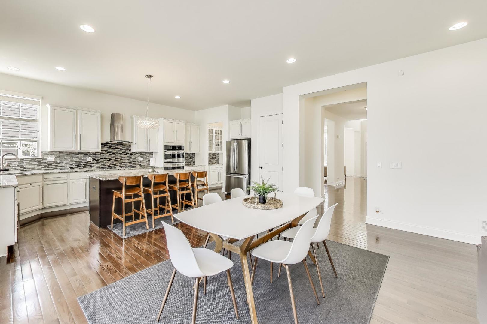 1064 Ridgeview Drive Inverness, IL 60010 - Photo 13 of 48 a kitchen with a dining table chairs and refrigerator
