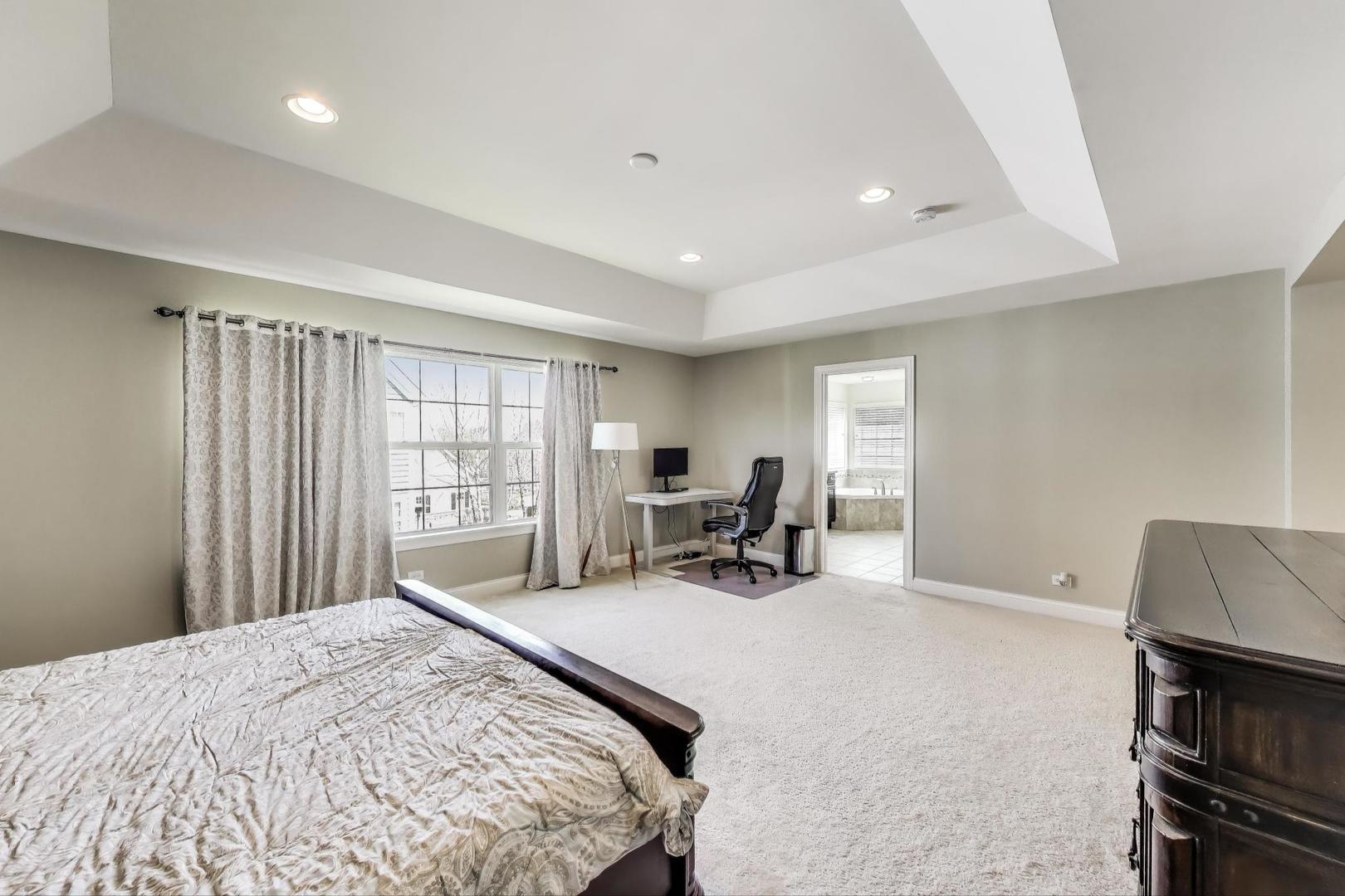 1064 Ridgeview Drive Inverness, IL 60010 - Photo 20 of 48 a bedroom with a bed a table and a large window