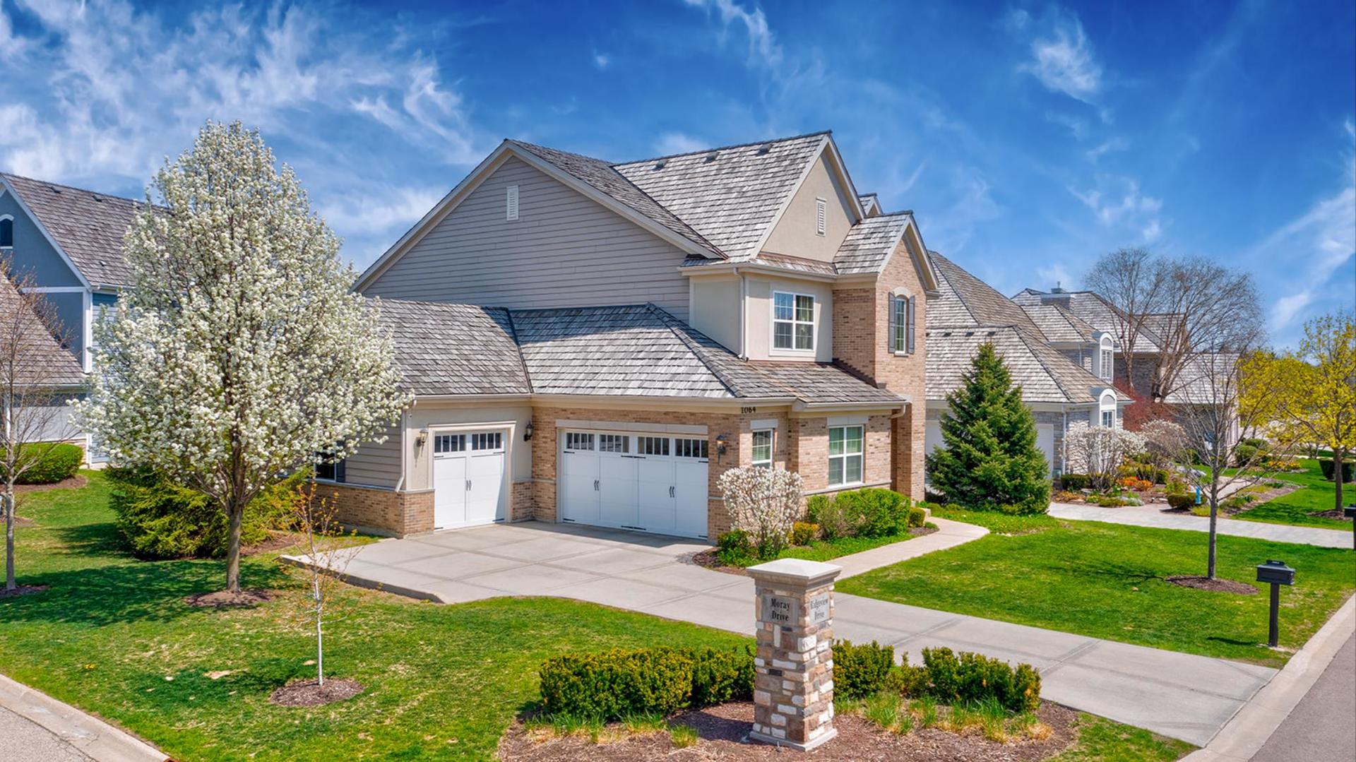 1064 Ridgeview Drive Inverness, IL 60010 - Photo 2 of 48 a front view of a house with a yard and potted plants