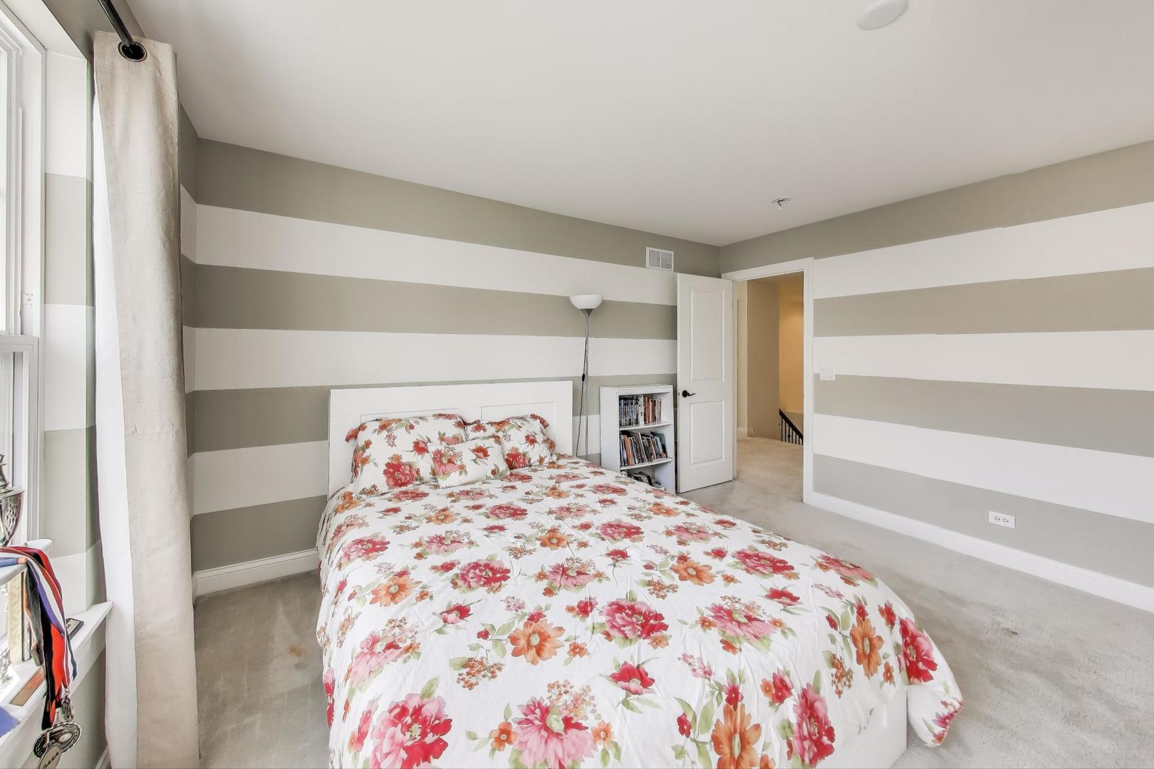 1064 Ridgeview Drive Inverness, IL 60010 - Photo 25 of 48 a bedroom with a large bed and a chandelier