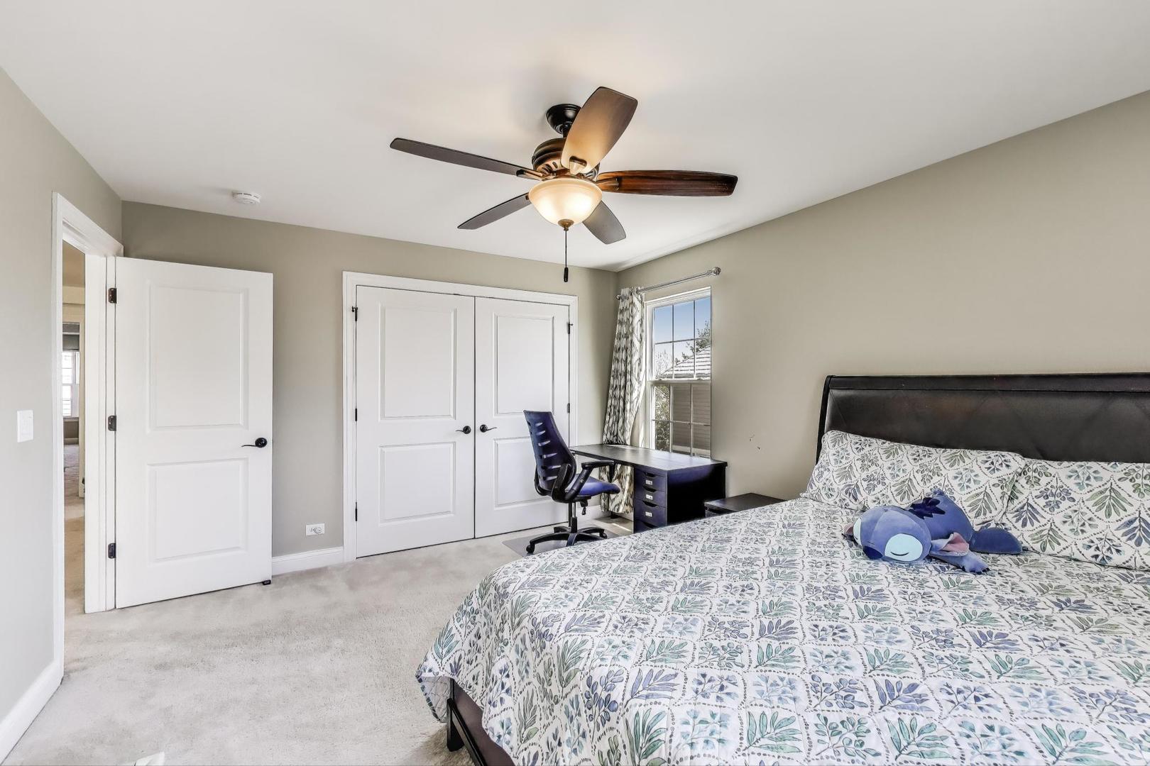 1064 Ridgeview Drive Inverness, IL 60010 - Photo 27 of 48 a bedroom with a bed and a chandelier