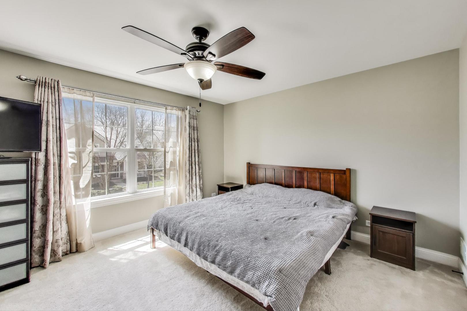 1064 Ridgeview Drive Inverness, IL 60010 - Photo 28 of 48 a bedroom with a large bed and a tv