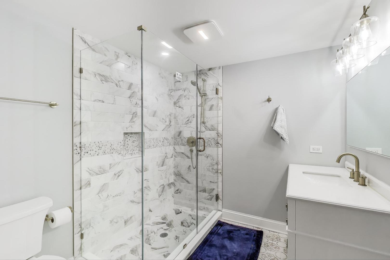 1064 Ridgeview Drive Inverness, IL 60010 - Photo 36 of 48 a bathroom with a shower toilet and sink