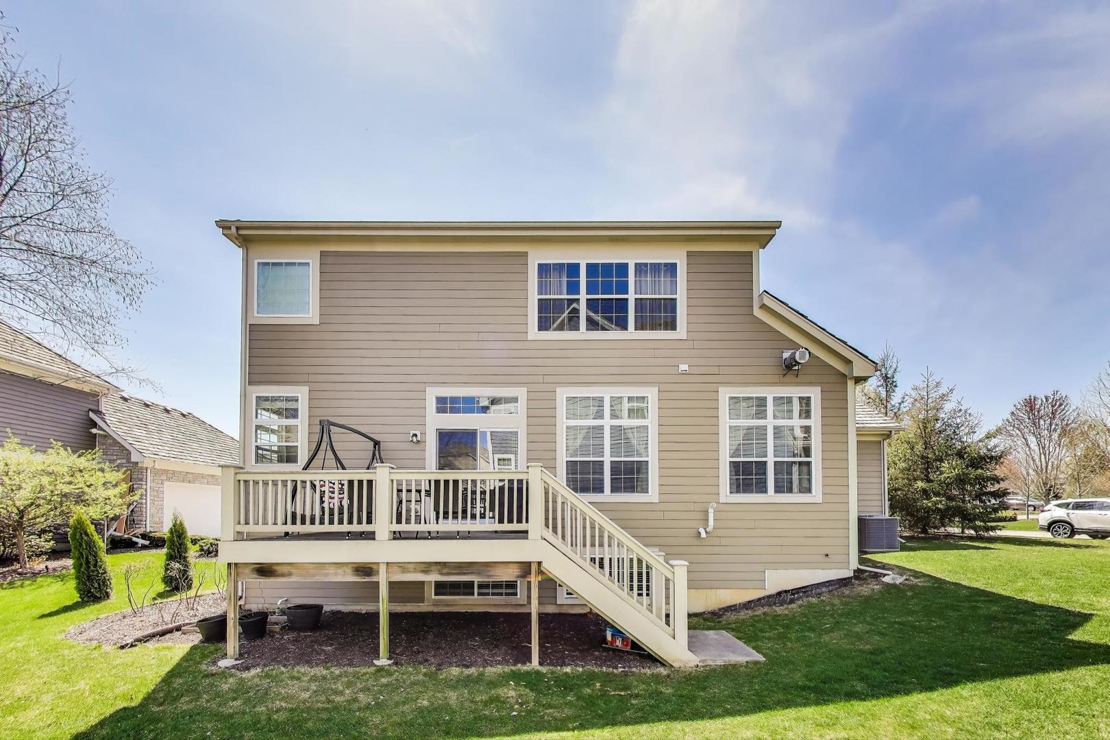 1064 Ridgeview Drive Inverness, IL 60010 - Photo 39 of 48 a front view of a house with a yard table and chairs