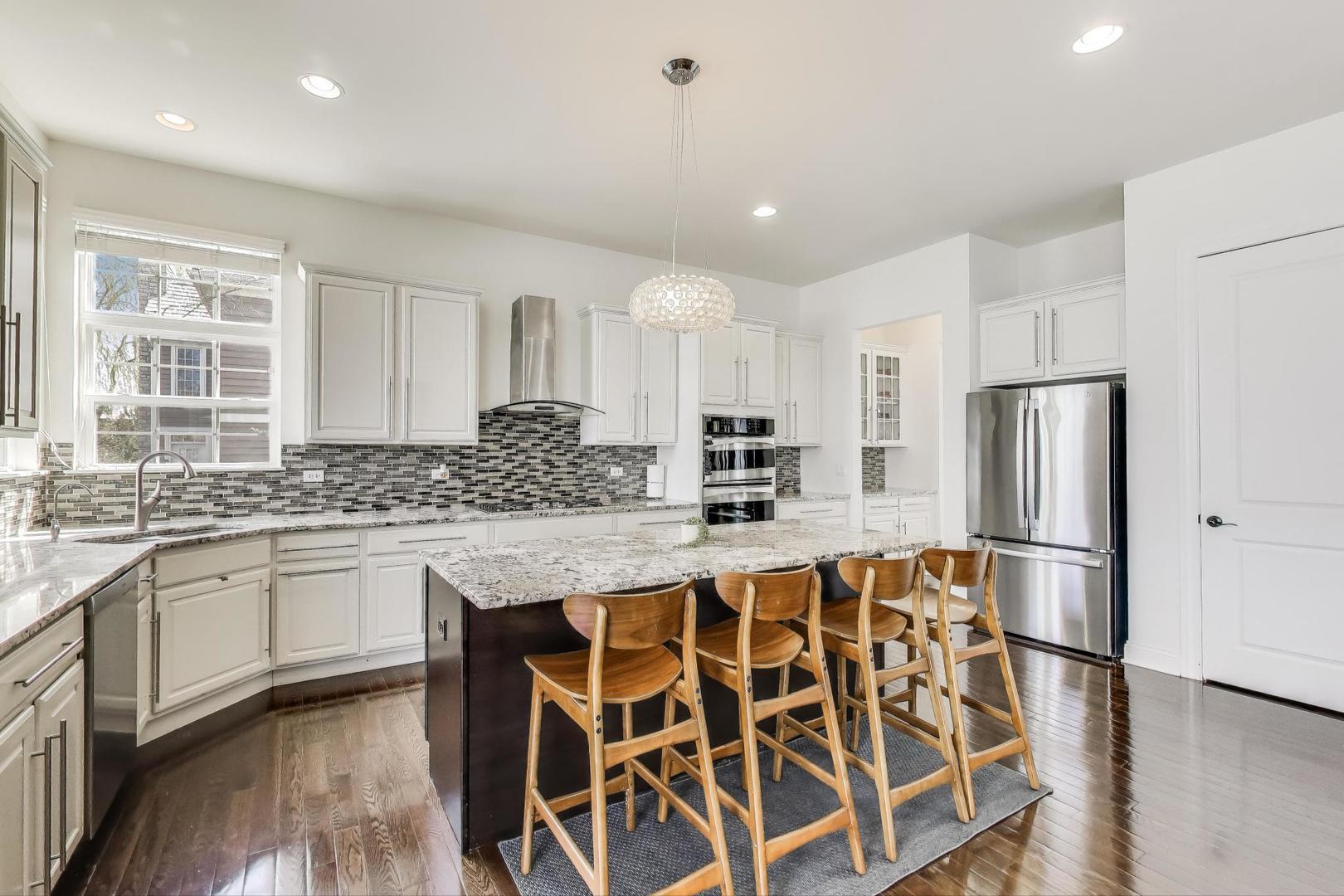 1064 Ridgeview Drive Inverness, IL 60010 - Photo 9 of 48 a kitchen with stainless steel appliances granite countertop a sink and a refrigerator