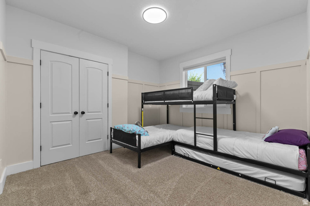 500 North 516th Street West, Unit 19 Mapleton, UT 84664 - Photo 28 of 41 Carpeted room featuring a double-door closet with black hardware, a single window with white trim, and wainscoting paneling