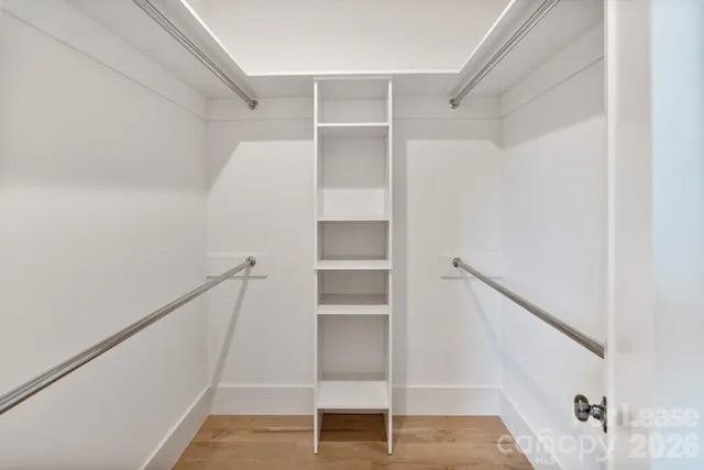 a view of walk in closet with empty racks