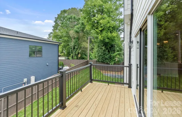a view of a wooden balcony and trees