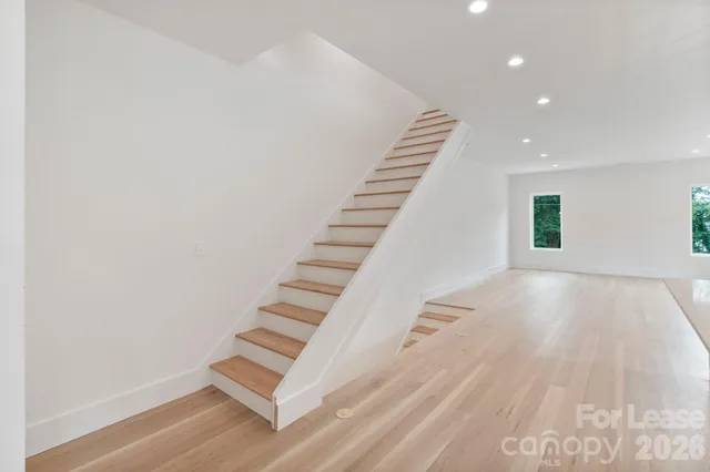 a view of an entryway with wooden floor