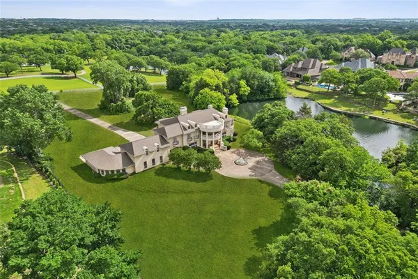 an aerial view of a house with a yard