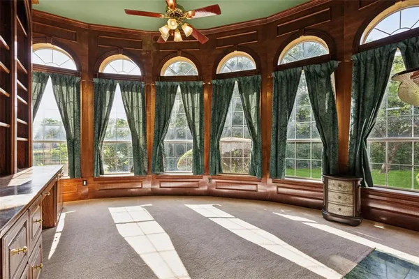 a spacious bedroom with a large bed and a chandelier