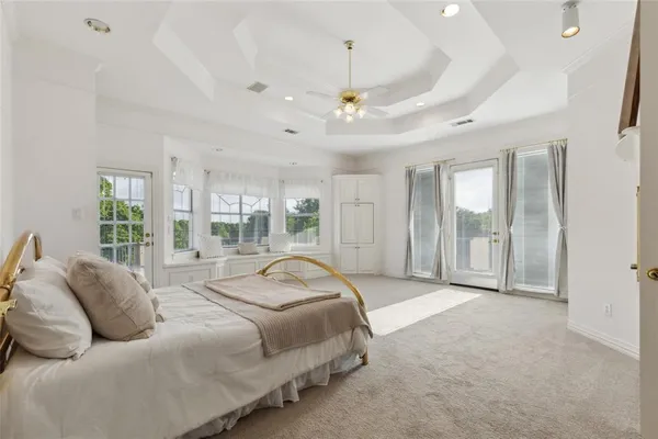 a spacious bedroom with a bed and a couch