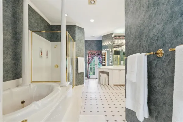 a bathroom with a bathtub shower sink and mirror