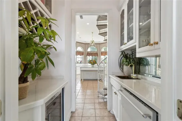 a kitchen with a sink and chairs