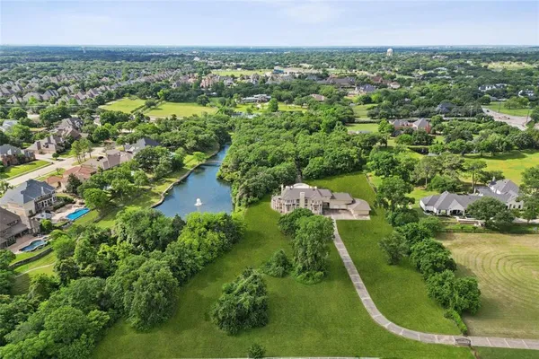 an aerial view of a residential houses with yard