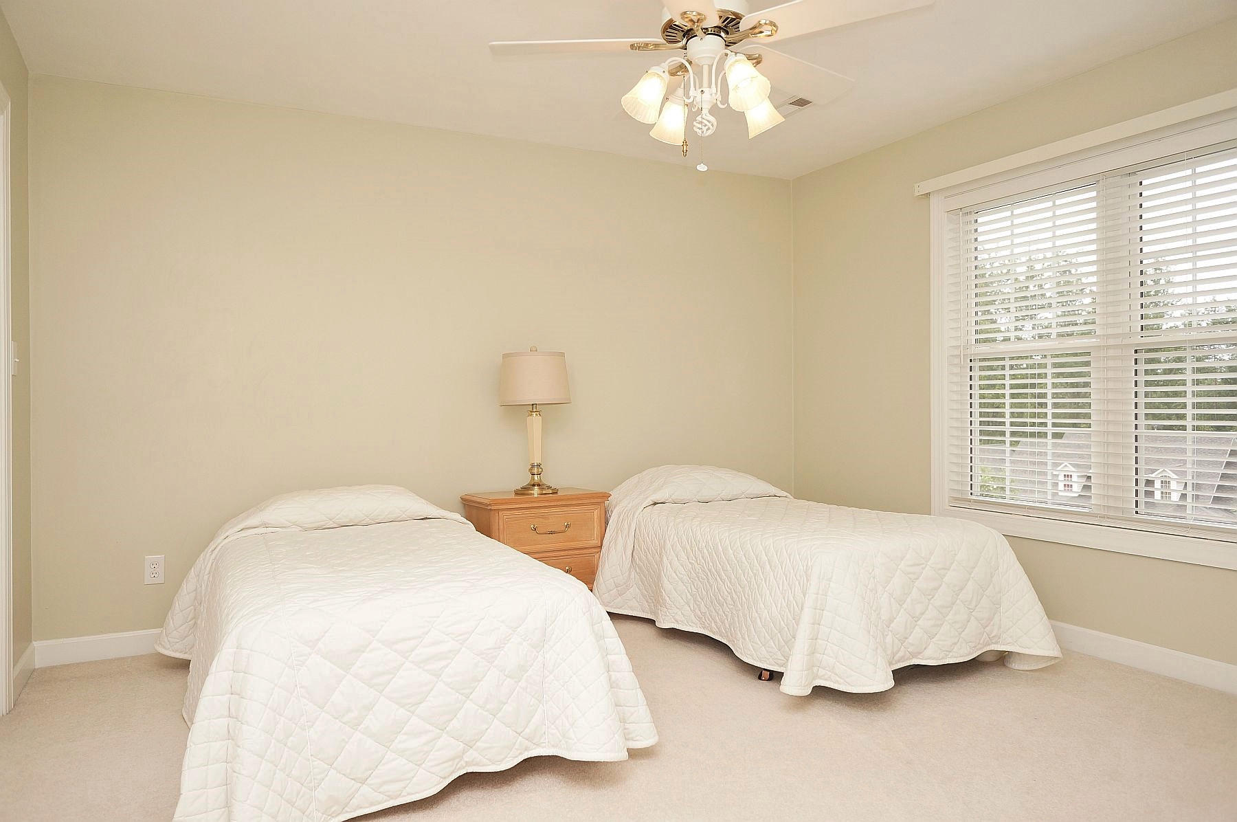 25 Claybrook Court Blue Ridge, VA 24064 - Photo 49 of 81 a bedroom with two beds and a chandelier