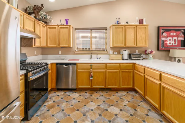 a kitchen with a stove sink and cabinets