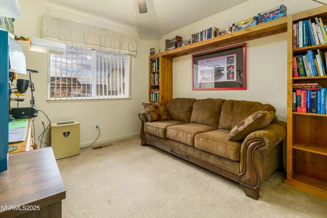 a living room with furniture workspace and a book shelf