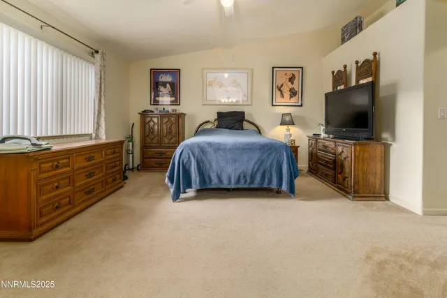 a bedroom with furniture and a flat screen tv