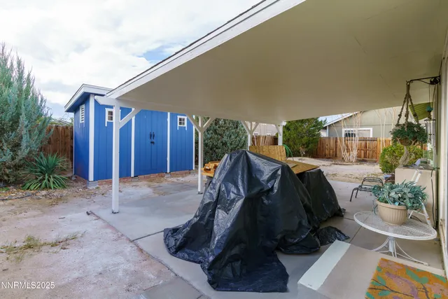 a view of balcony with furniture and potted plants