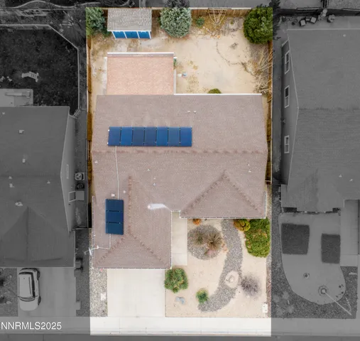 an aerial view of a house with a backyard