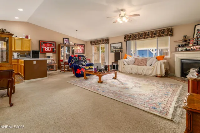 a living room with furniture a flat screen tv and a couch