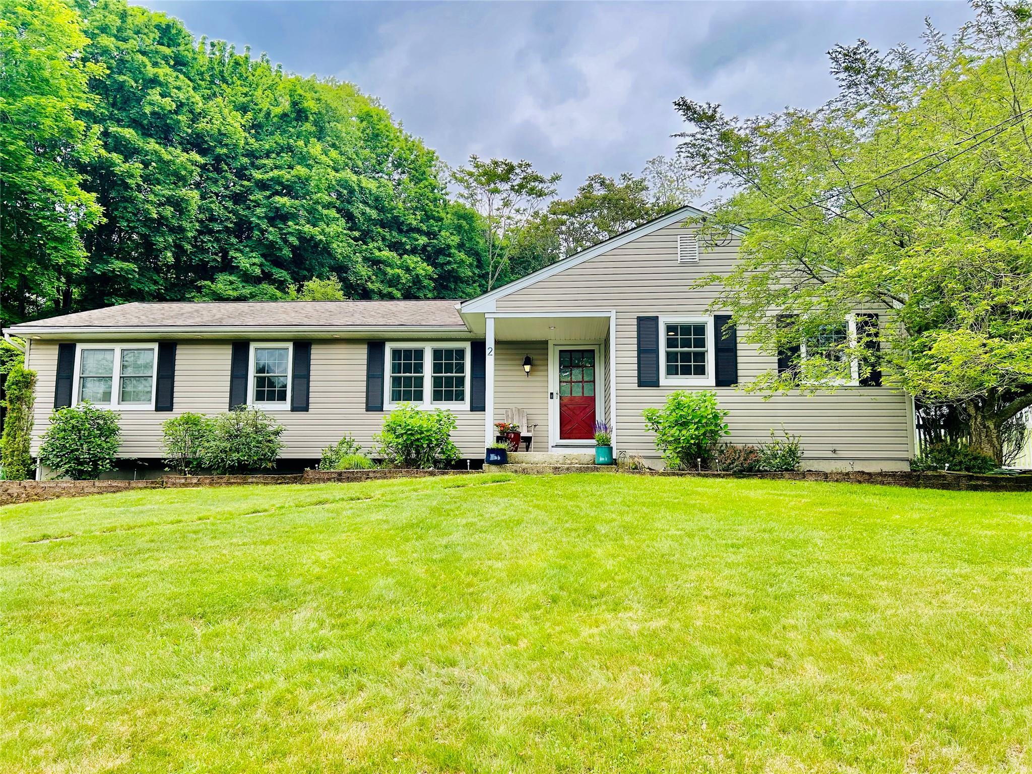a front view of a house with a garden