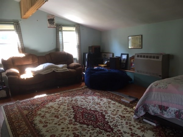 23 Maple Street Chester, MA 01011 - Photo 3 of 11 a living room with a bed furniture and a window