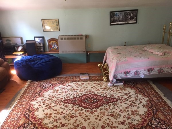 23 Maple Street Chester, MA 01011 - Photo 4 of 11 a bedroom with a bed and a lamp on dresser
