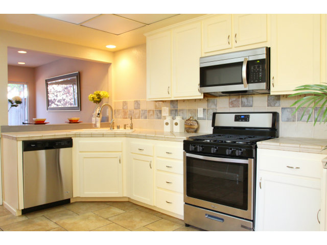712 Superior Road Milpitas, CA 95035 - Photo 9 of 20 a kitchen with stainless steel appliances white cabinets and a stove top oven