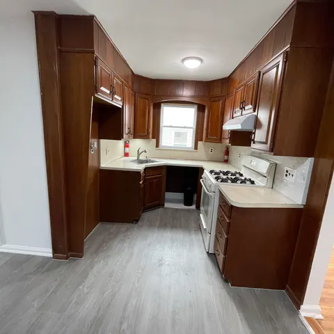 a kitchen with a sink a stove a refrigerator and a oven