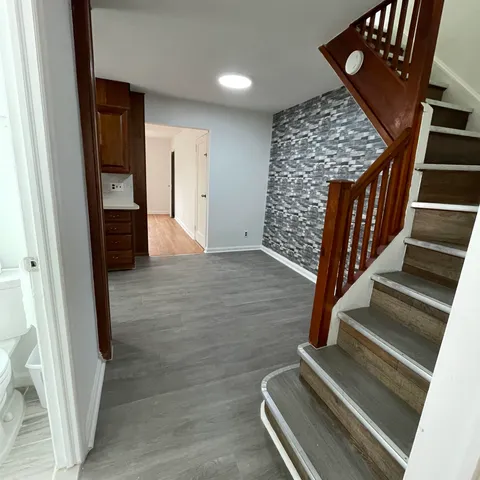 a view of an entryway with wooden floor