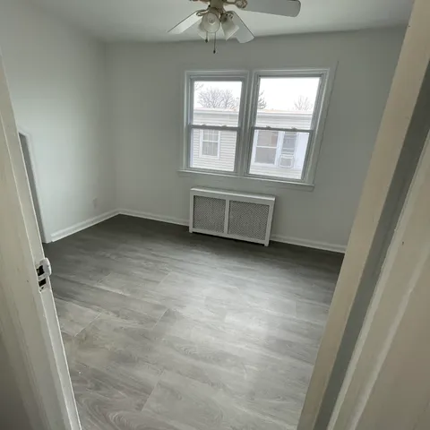 an empty room with a fireplace and windows