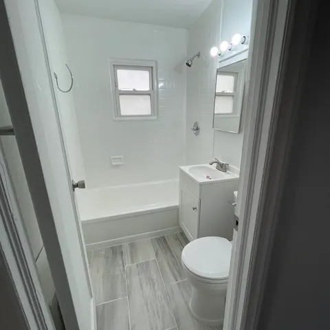 a bathroom with a toilet a sink and bathtub