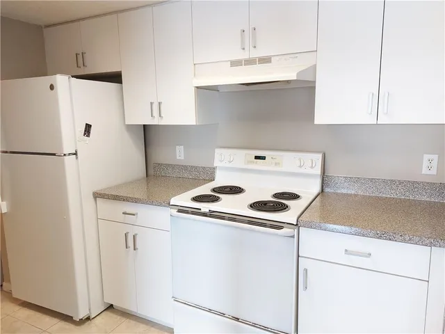 a kitchen with a stove a refrigerator and a sink