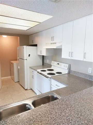 an empty room with closet and windows