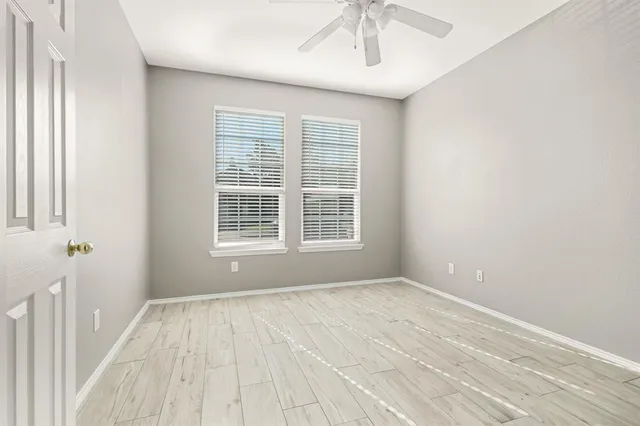 a view of wooden floor and windows in a room