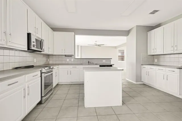 a kitchen with cabinets and white appliances