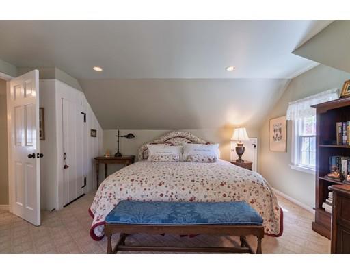 37 Downing Street Hingham, MA 02043 - Photo 15 of 20 a bedroom with a bed a table and a book shelf