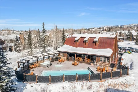 a view of a terrace with chairs and wooden fence
