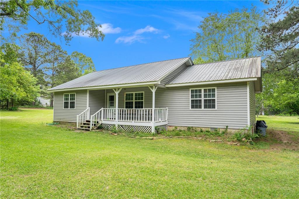 345 Laurel Road Carrollton, GA 30117 - Photo 1 of 1 a backyard of a house with garden and barbeque oven