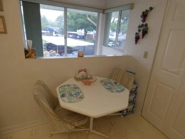 a view of a dining room with furniture and window