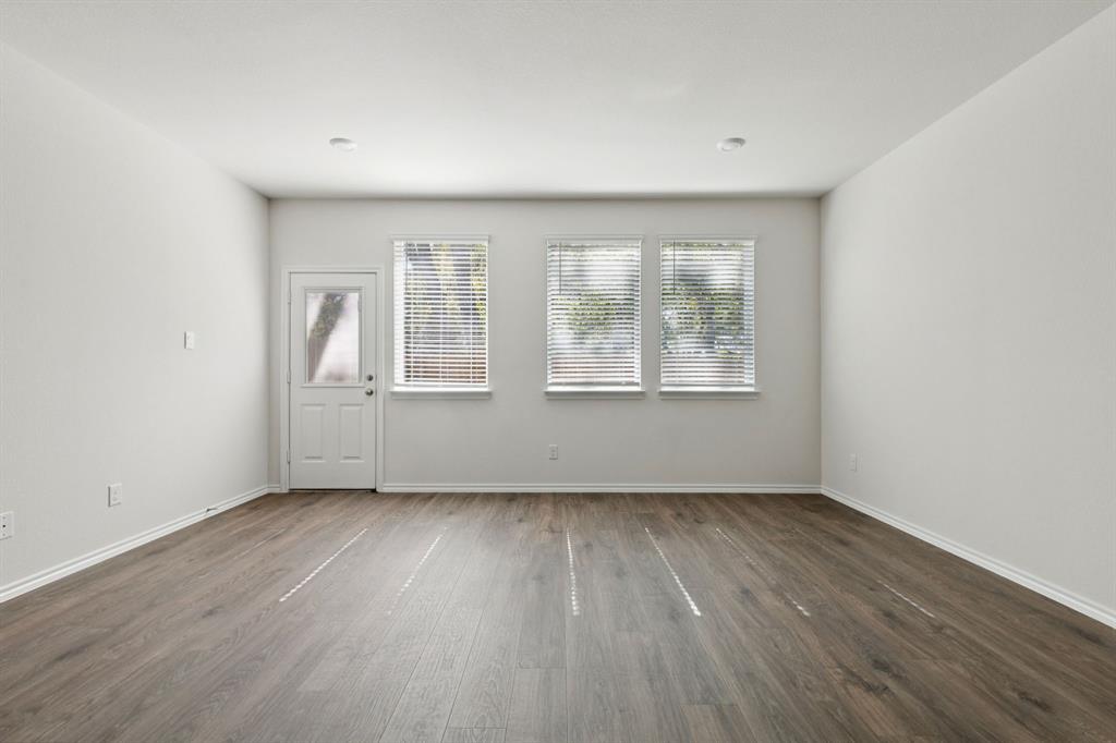 317 Clematis Street Princeton, TX 75407 - Photo 27 of 38 Unfurnished room featuring plenty of natural light and dark wood-type flooring