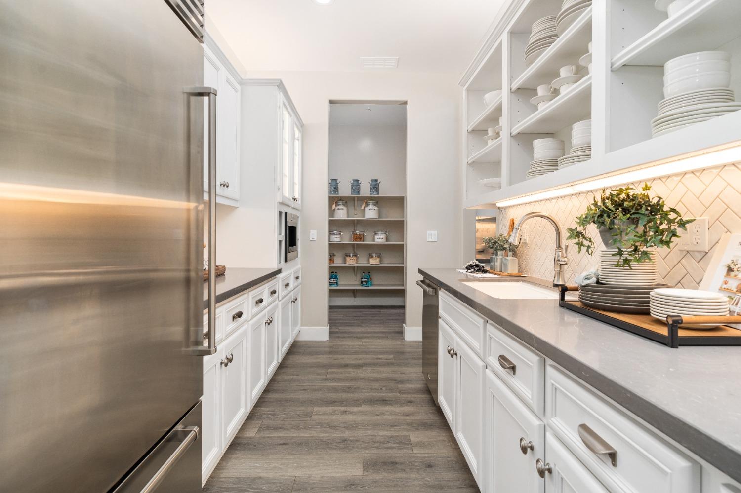 1754 Lester Avenue Clovis, CA 93619 - Photo 20 of 59 a kitchen with kitchen island a sink stove and cabinets