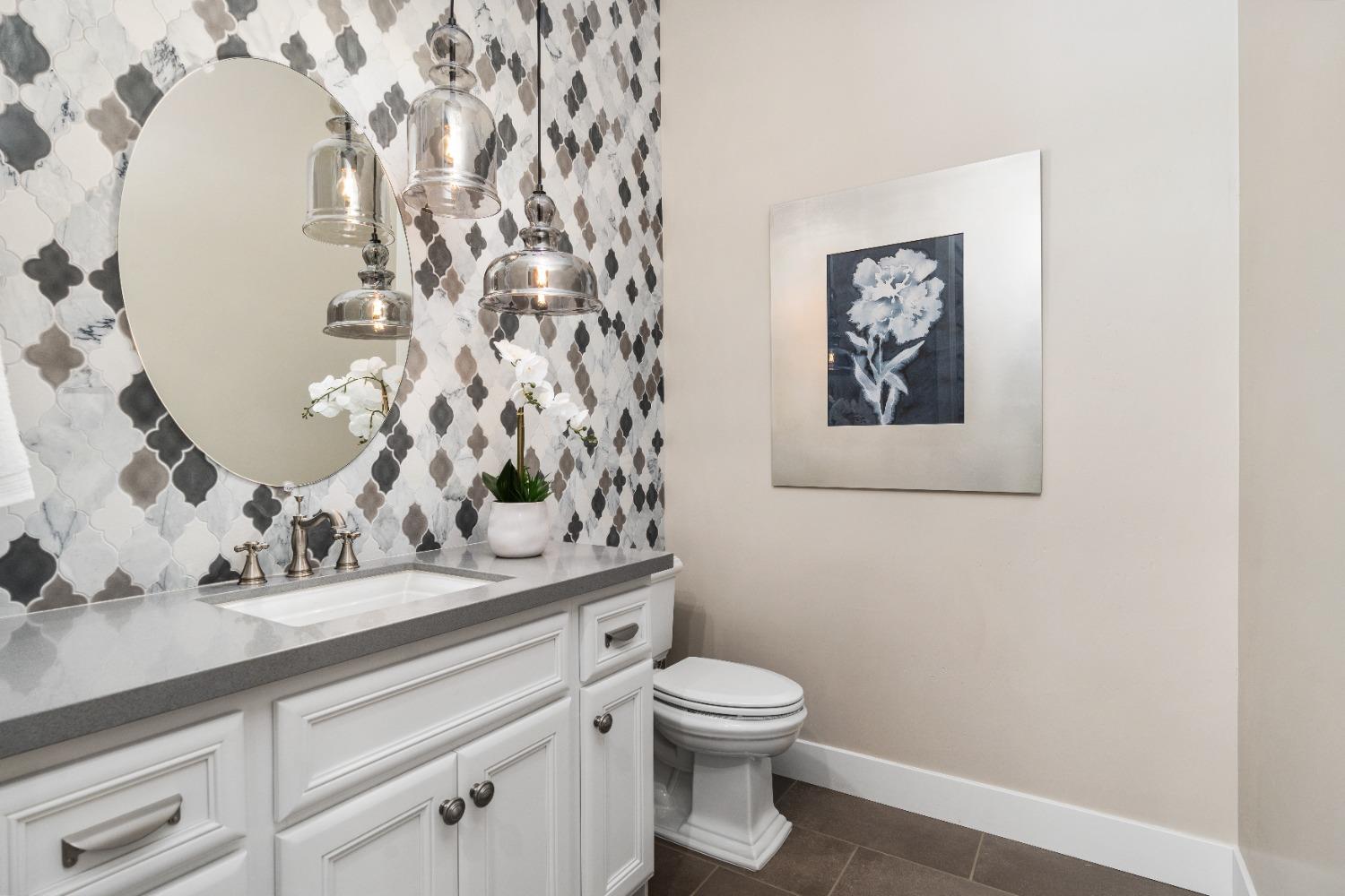 1754 Lester Avenue Clovis, CA 93619 - Photo 27 of 59 a bathroom with a toilet sink and mirror