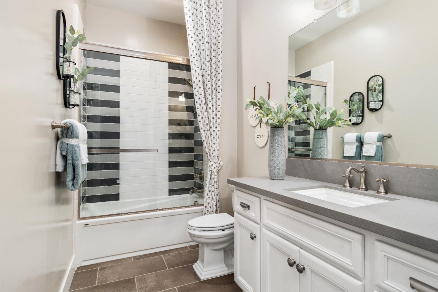 1754 Lester Avenue Clovis, CA 93619 - Photo 34 of 59 a bathroom with a sink a toilet and shower