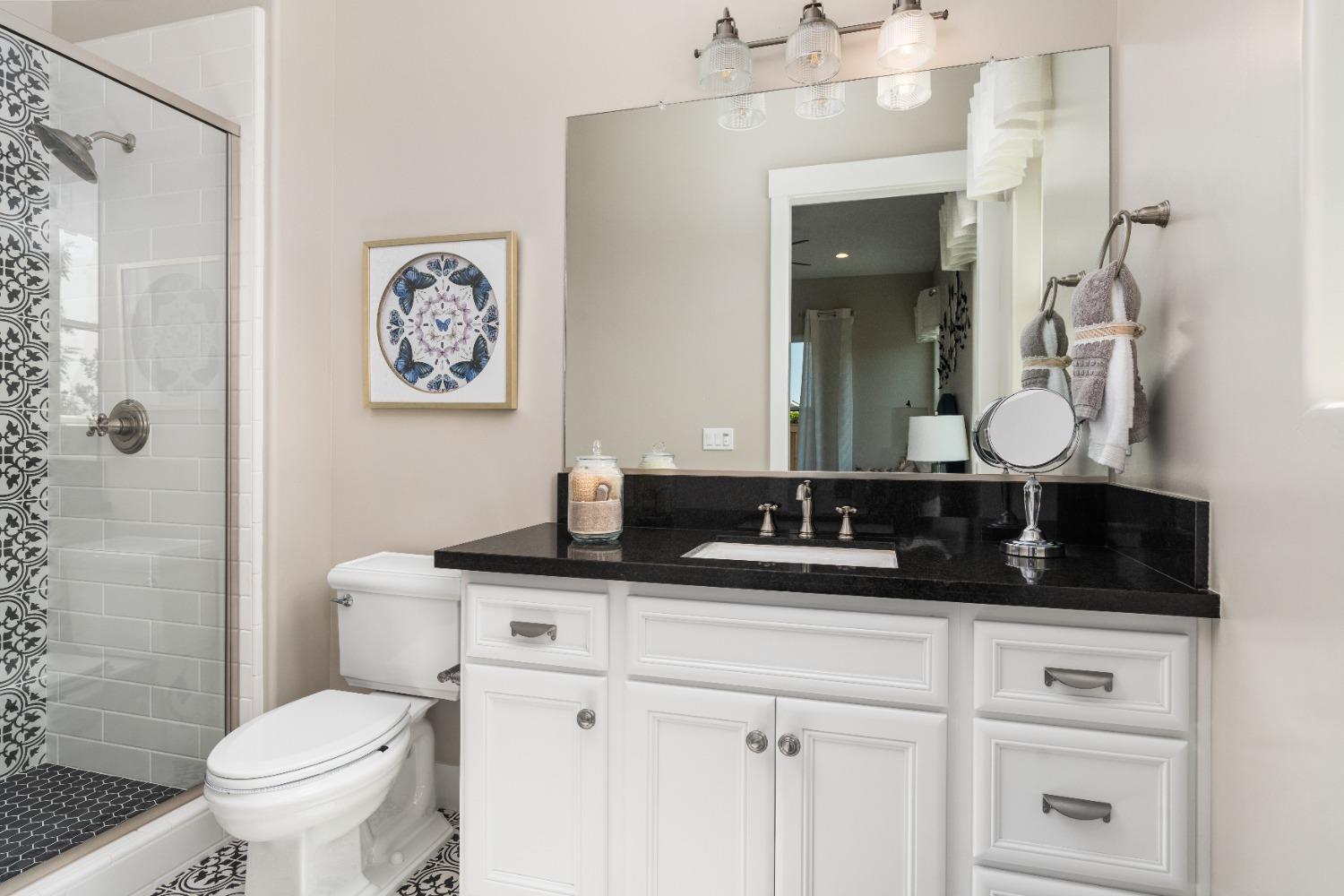 1754 Lester Avenue Clovis, CA 93619 - Photo 35 of 59 a bathroom with a toilet sink and mirror